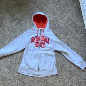 This is an orange and grey zip up hoodie that has never been worn.